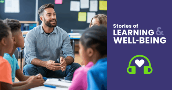 A male teacher working with a group of elementary school students.