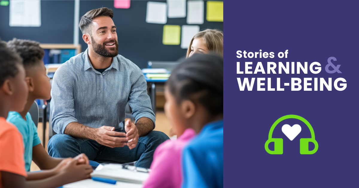 A male teacher working with a group of elementary school students.