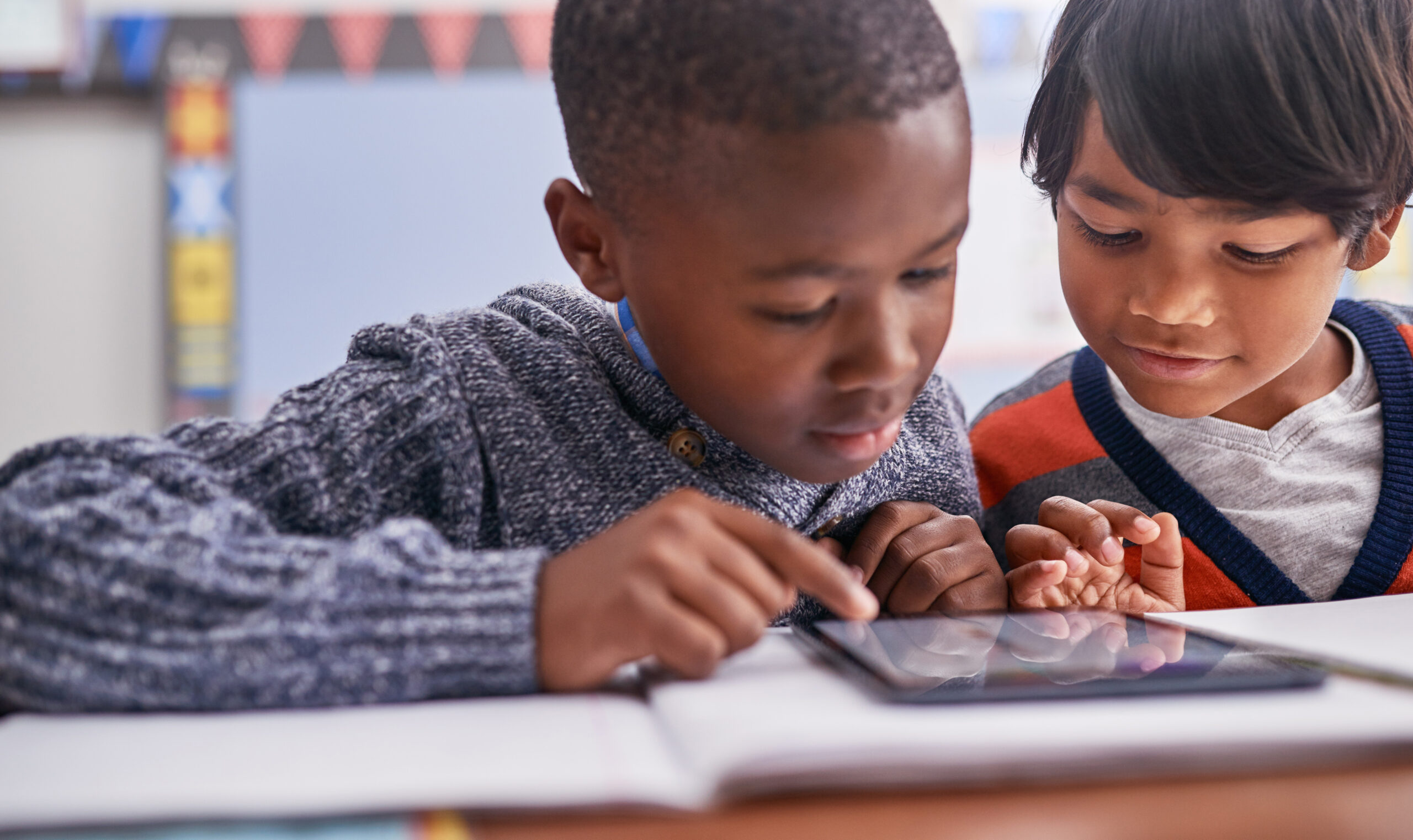 Students learning with tablet device.