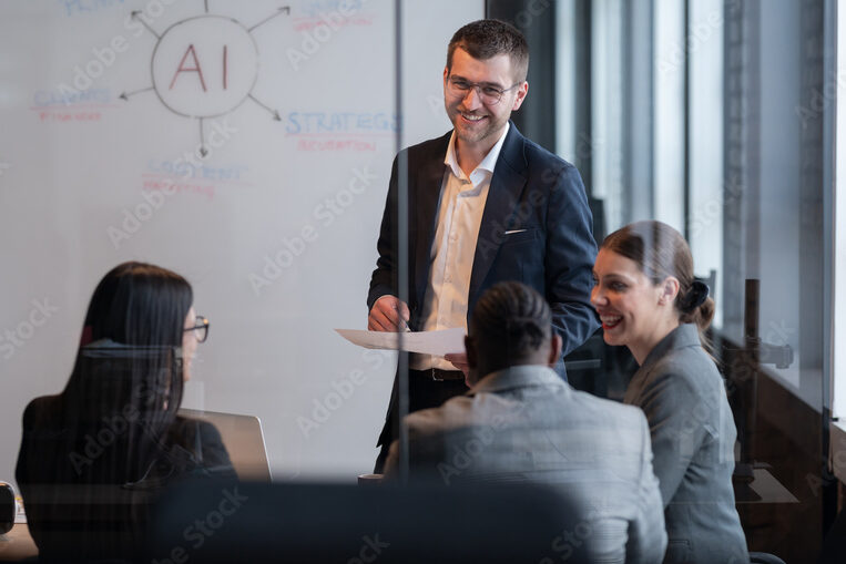 Smiling professionals in front of a whiteboard reading “AI"