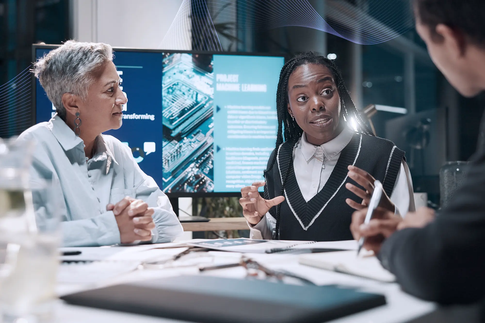 Three adults communicating in an office setting