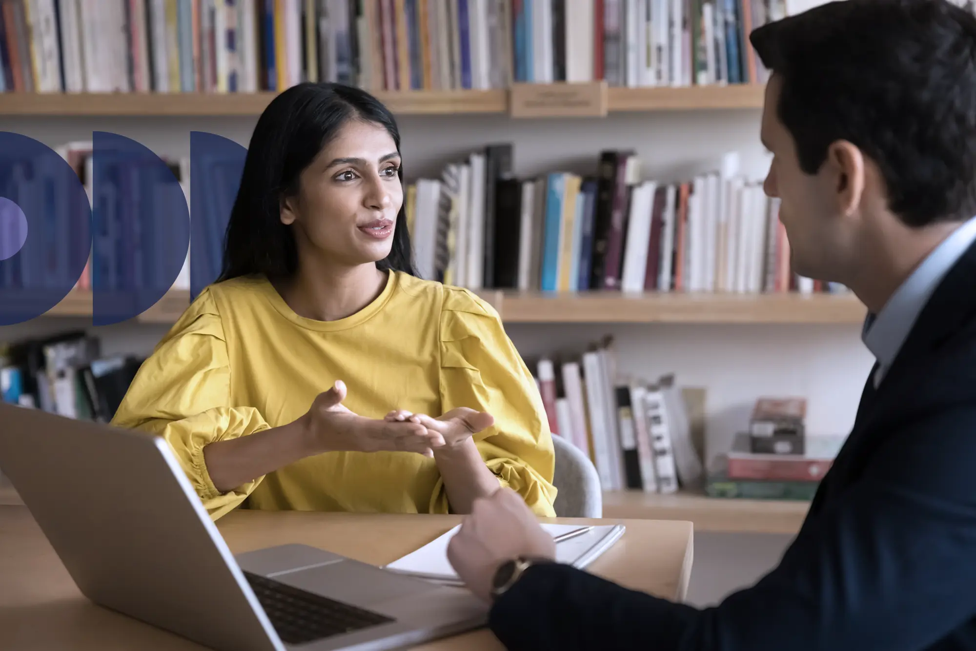 Two adults sitting together, having a conversation