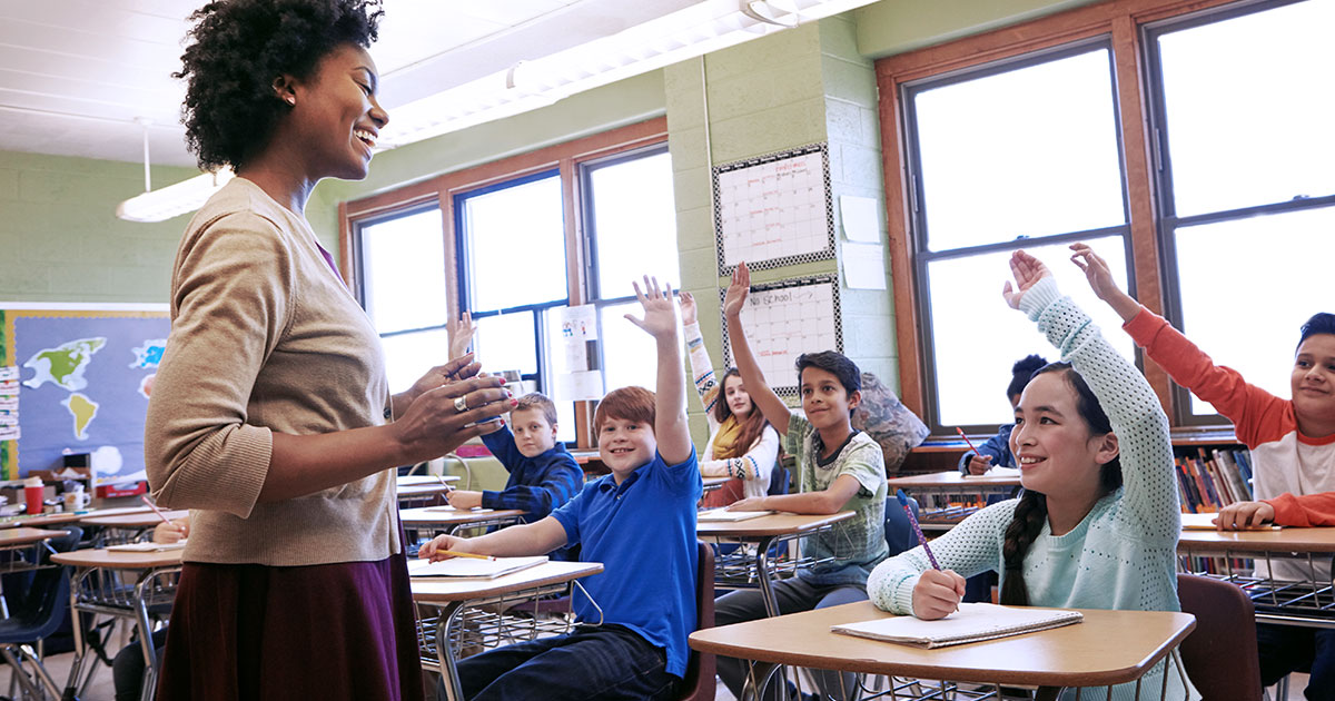 Students engaging with a teacher in the classroom