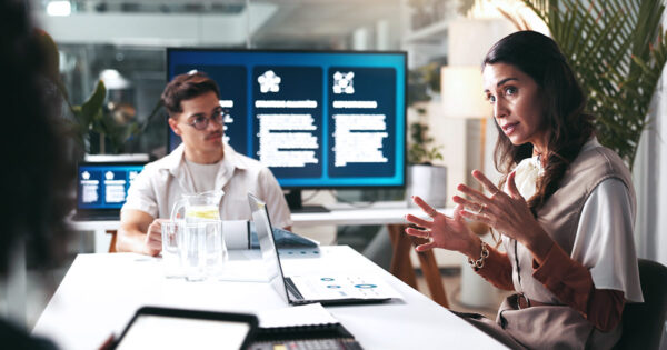 Educators in conversation, seated at a table