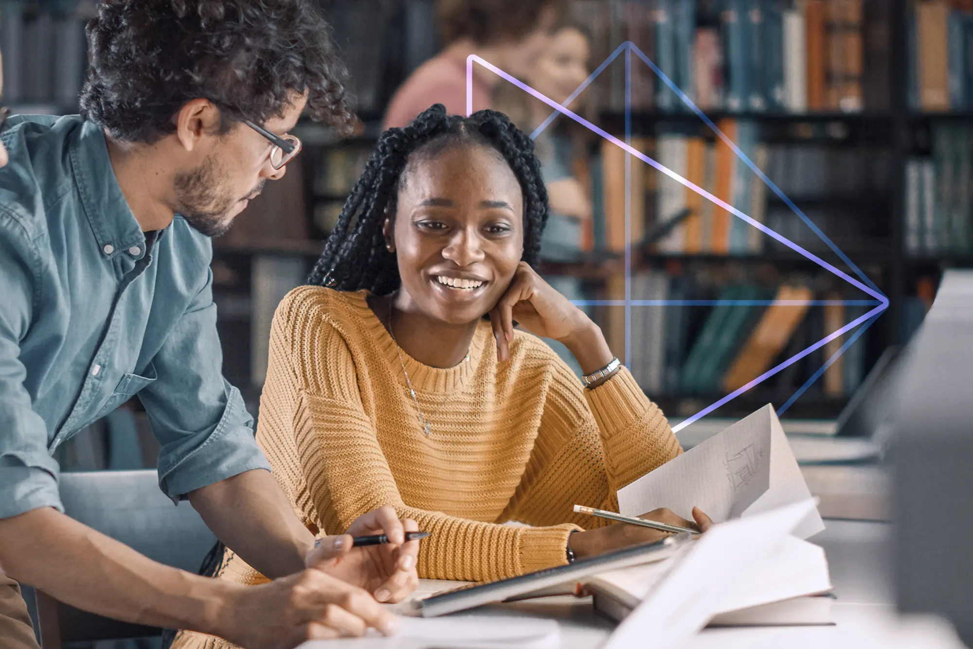 Educators in discussion while sitting at a table in a library