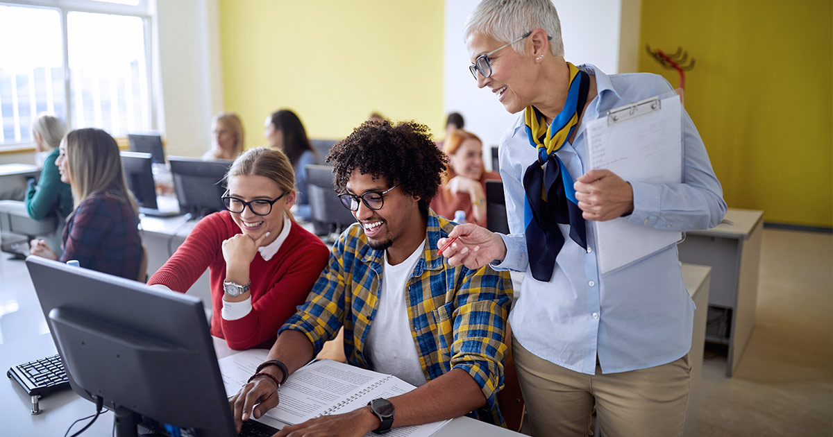 Adult students using technology in a classroom