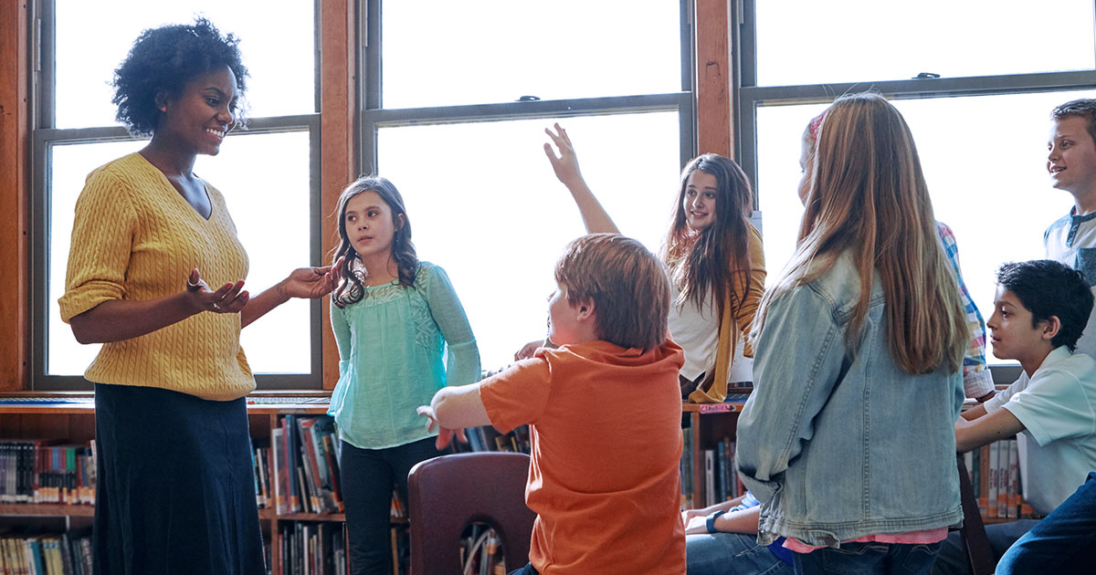 Students with teachers in a bright classroom