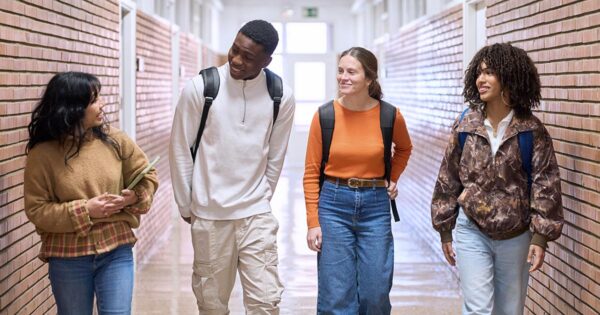 A group of students talking in the school hallway